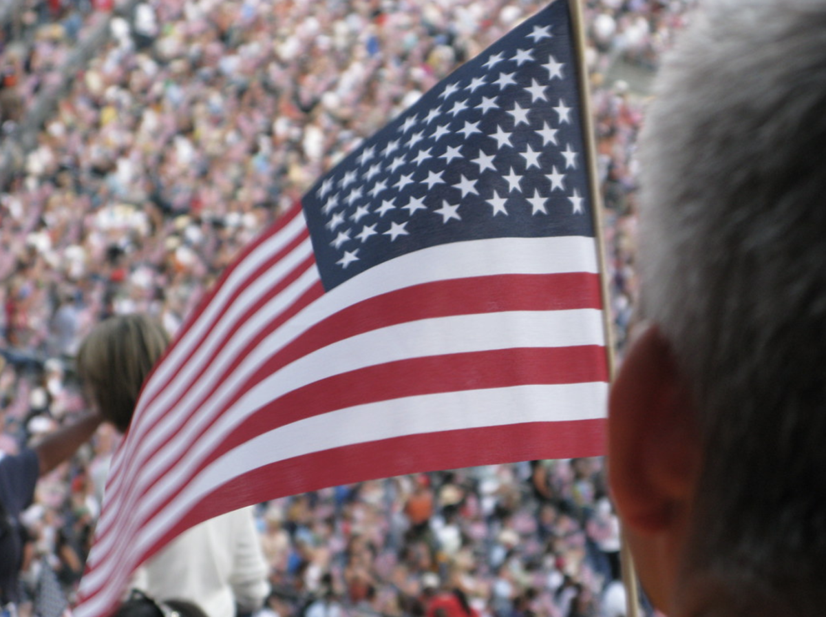 An American flag waving at a past DNC, taken by Kelly DeLay in 2008 and licensed under Creative Commons.